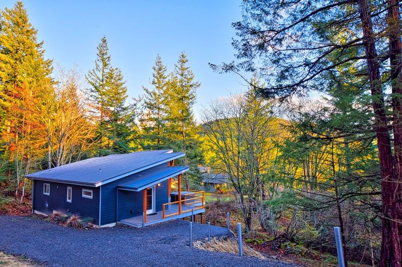 Home exterior among evergreens