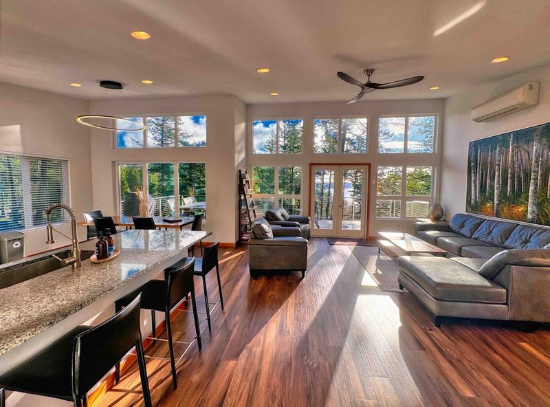 Open living and dining room with a wall of windows