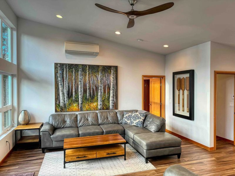Living room with leather sectional and tall windows