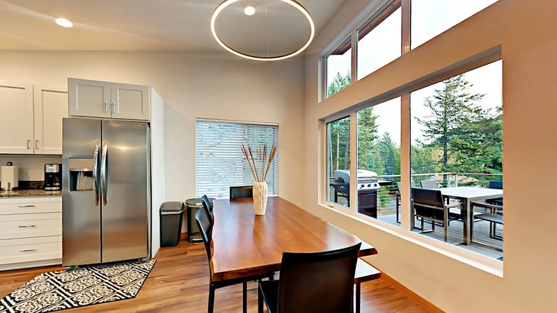 Dining table beside a wall of windows