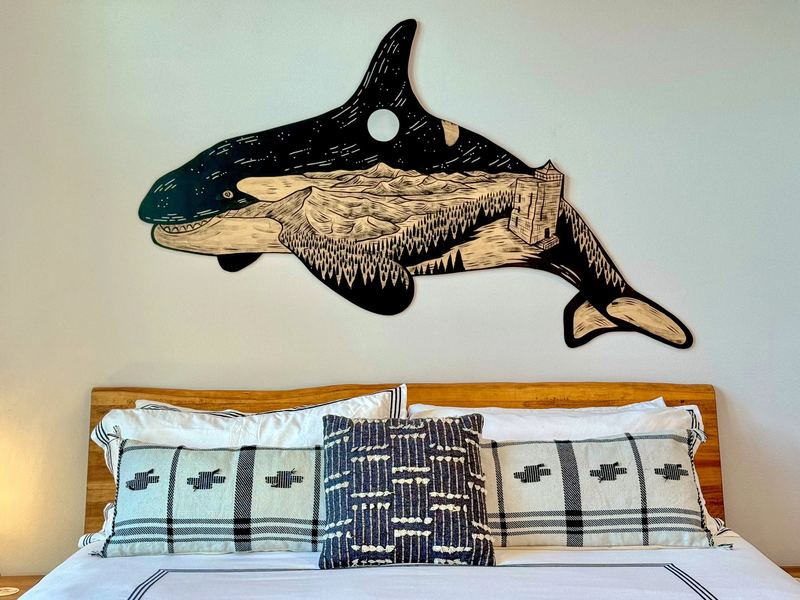 Orca artwork above the king bed