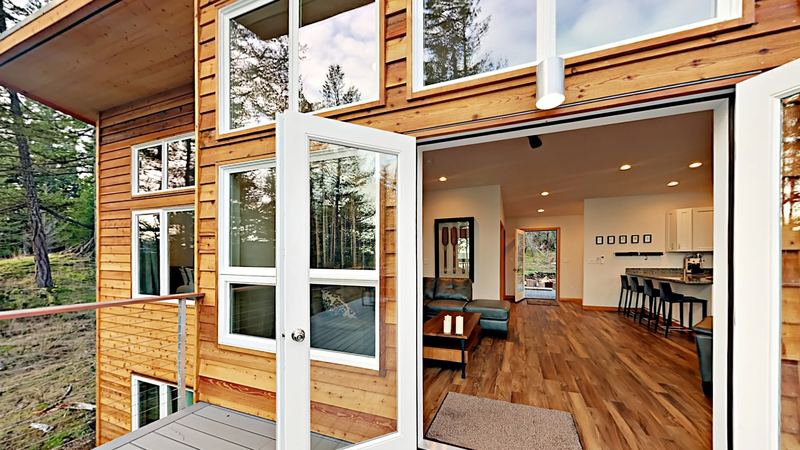 Glass doors opening from the deck into the living area